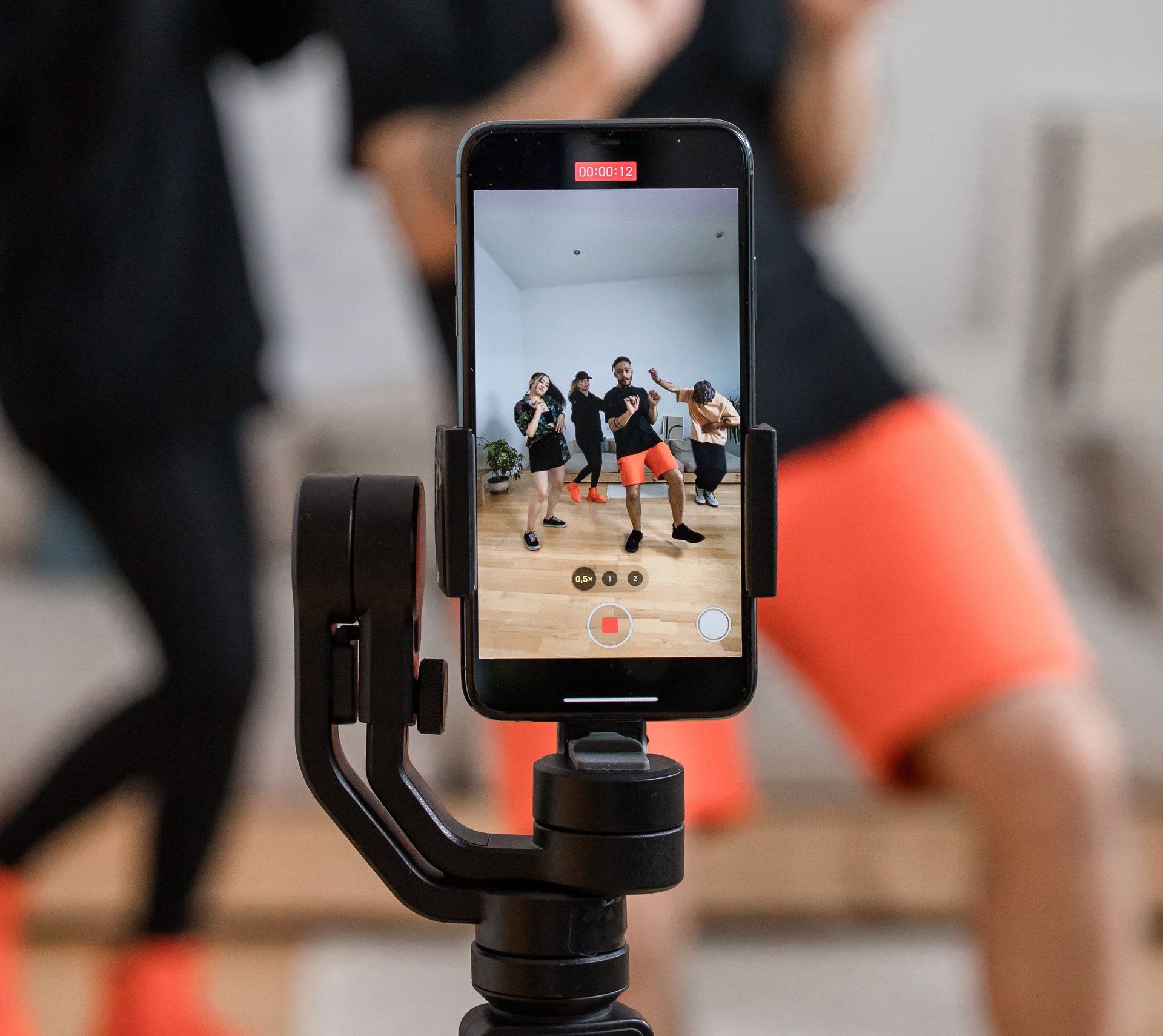 Fitness instructor recording fitness video on iPhone