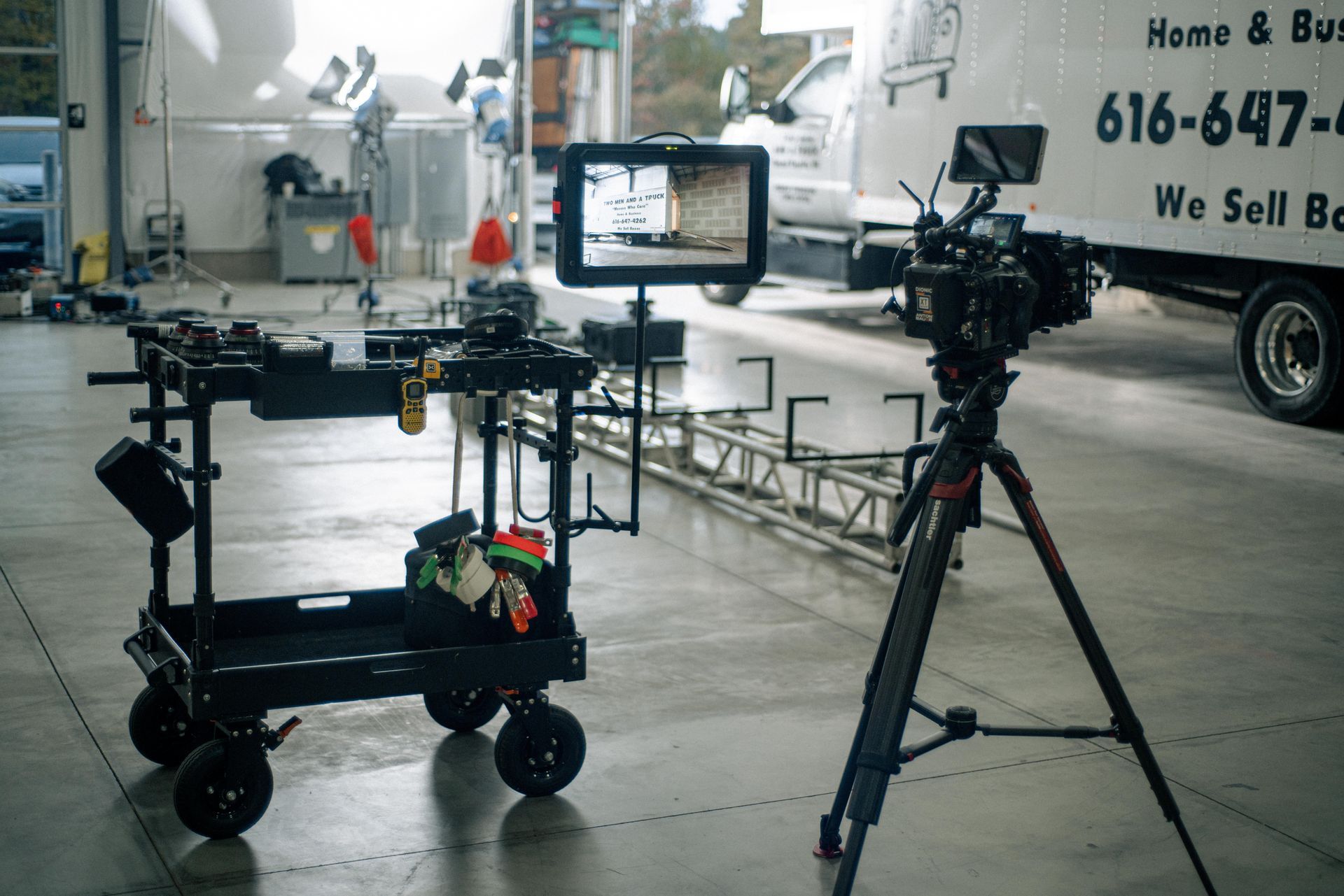 Behind the scenes film shoot cinema camera monitor and camera cart