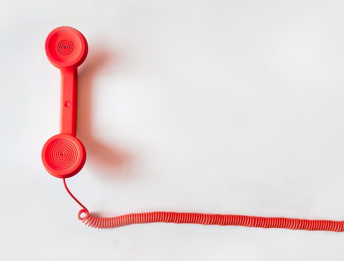 Top down image of all red phone receive over white background