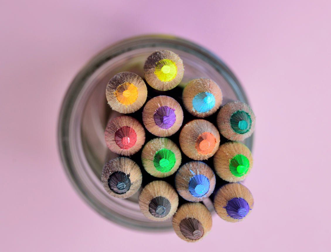 Top down close up image of colored pencils in jar