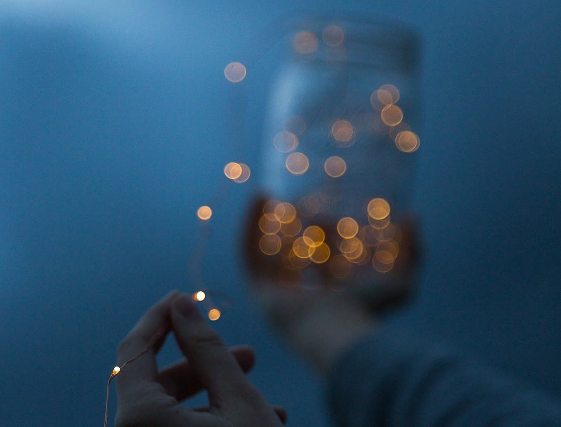 Image of hand holding ferry lights in a mason jar