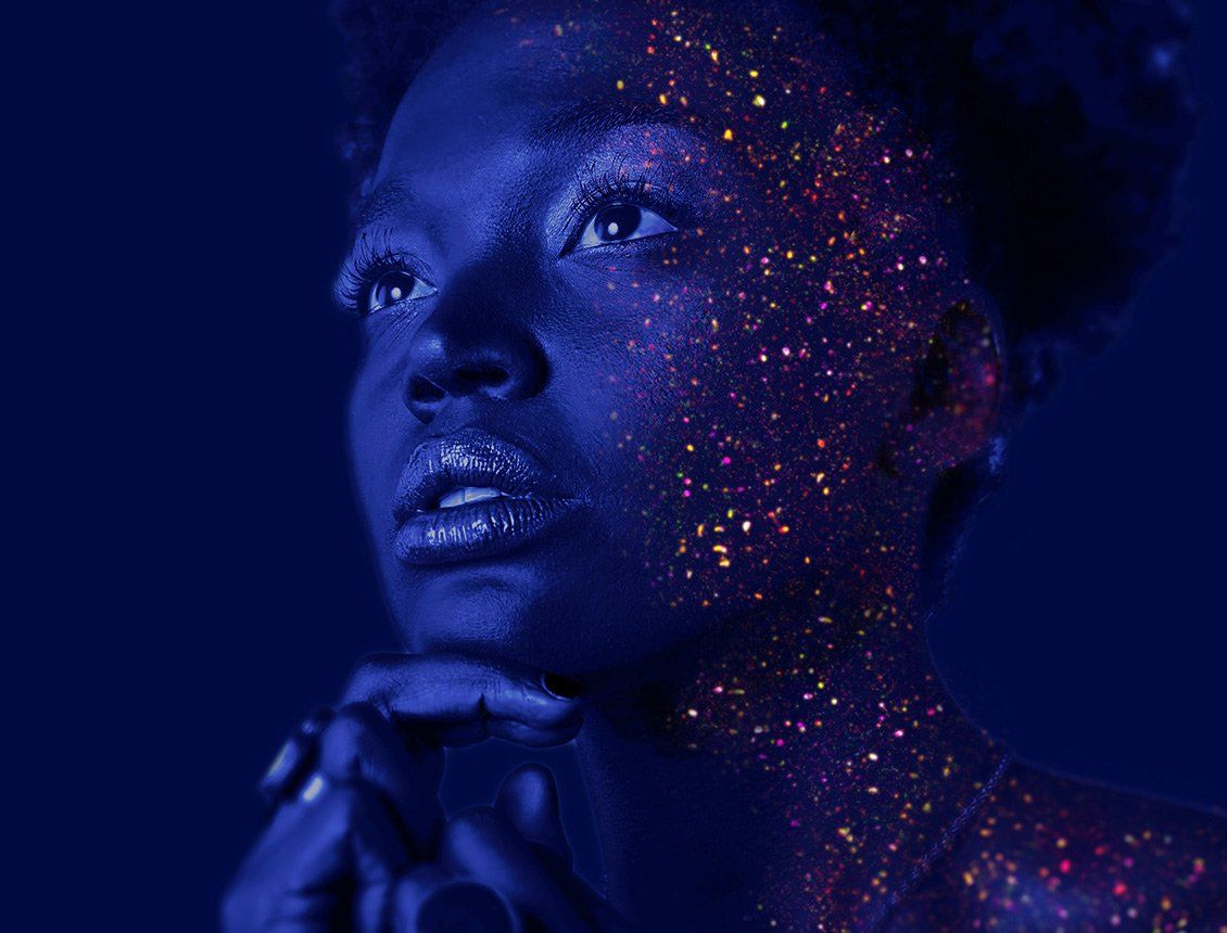 image of woman staring with glitter light on face