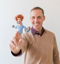 Matthew Billings headshot holding Bob Ross hand puppet for Spin Creative team page