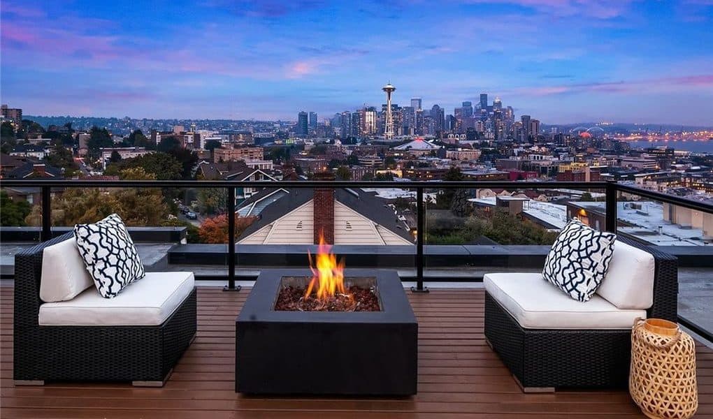 Image of Seattle, city and space needle on top of a rooftop with firepit