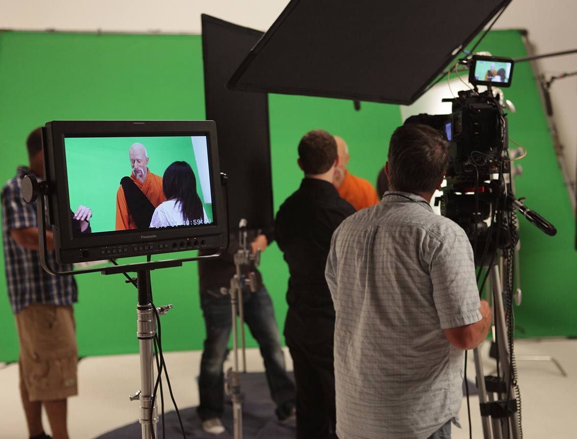Behind the scenes image of a Spin Creative video marketing project and video production green-screen shoot in a studio. 