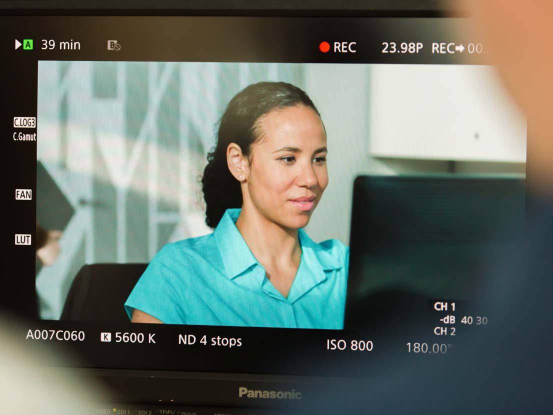 Behind the scenes actress on production monitor at Spin Creative shoot