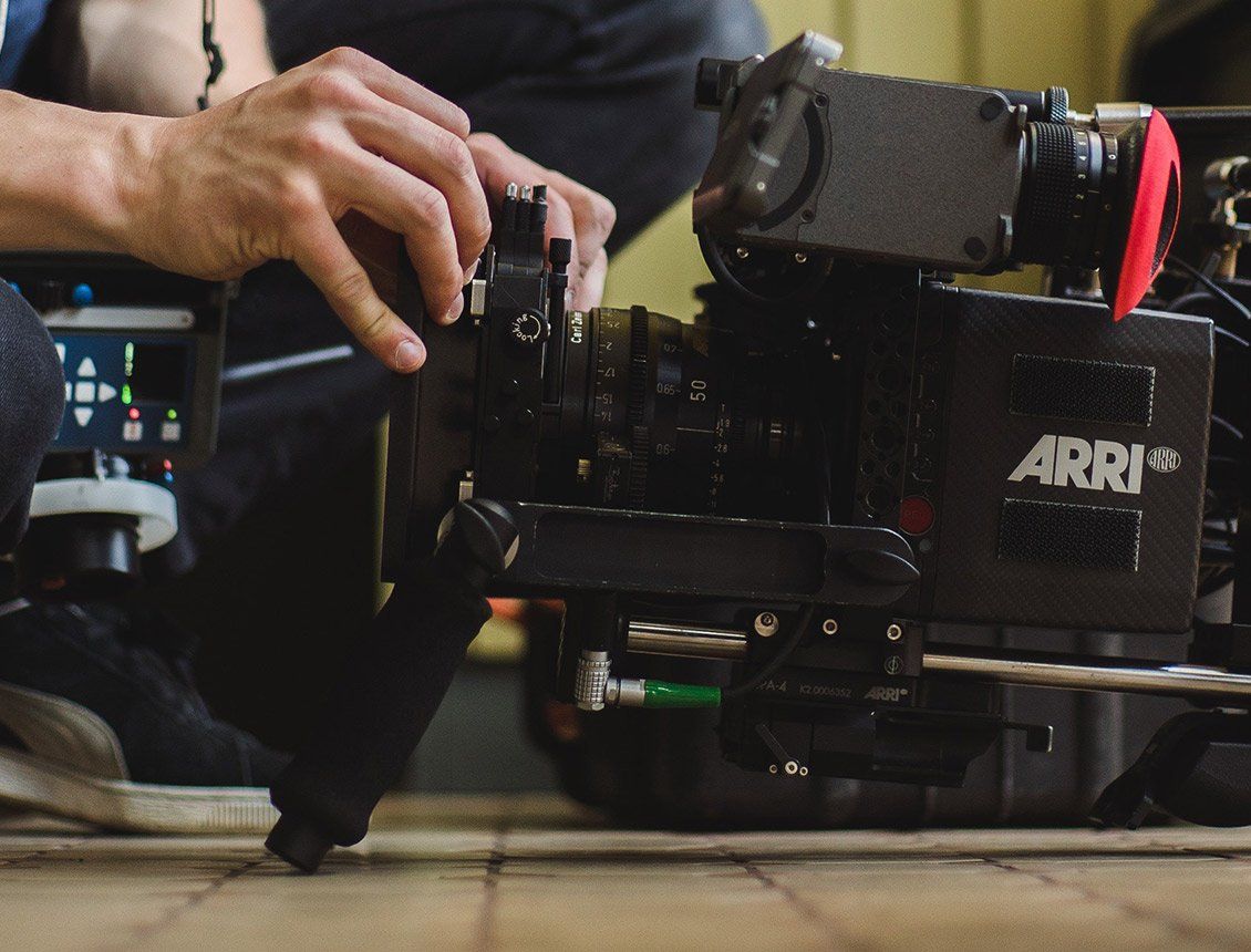 Image of a Arri Alexa cinema camera with a person changing the matte box