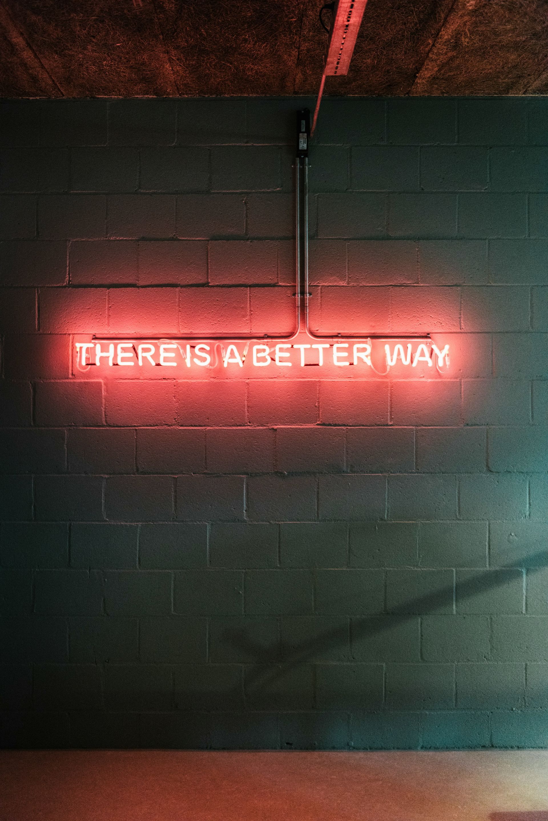 Red neon sign on brick wall: 