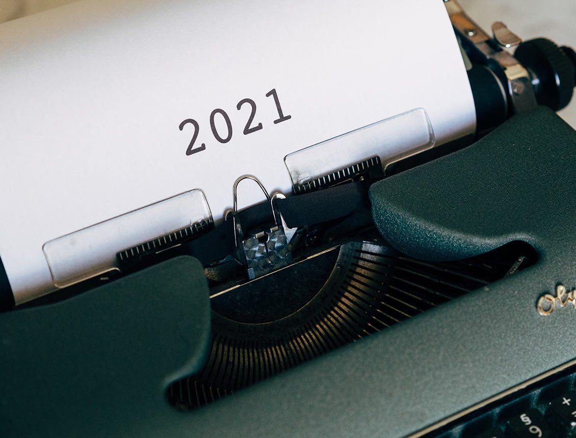 Close up old style typewriter with the numbers 2021 on a white piece of paper