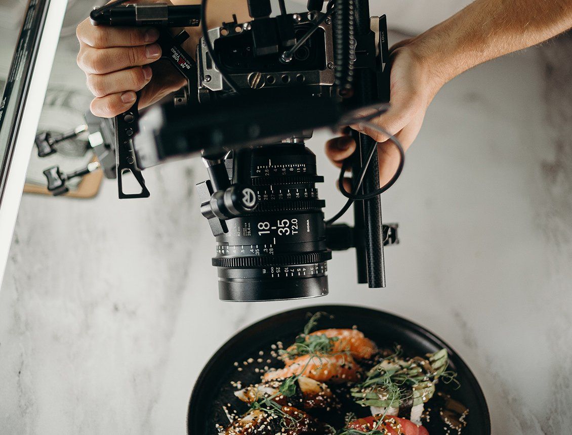 Image of cinema video camera filming a food dish