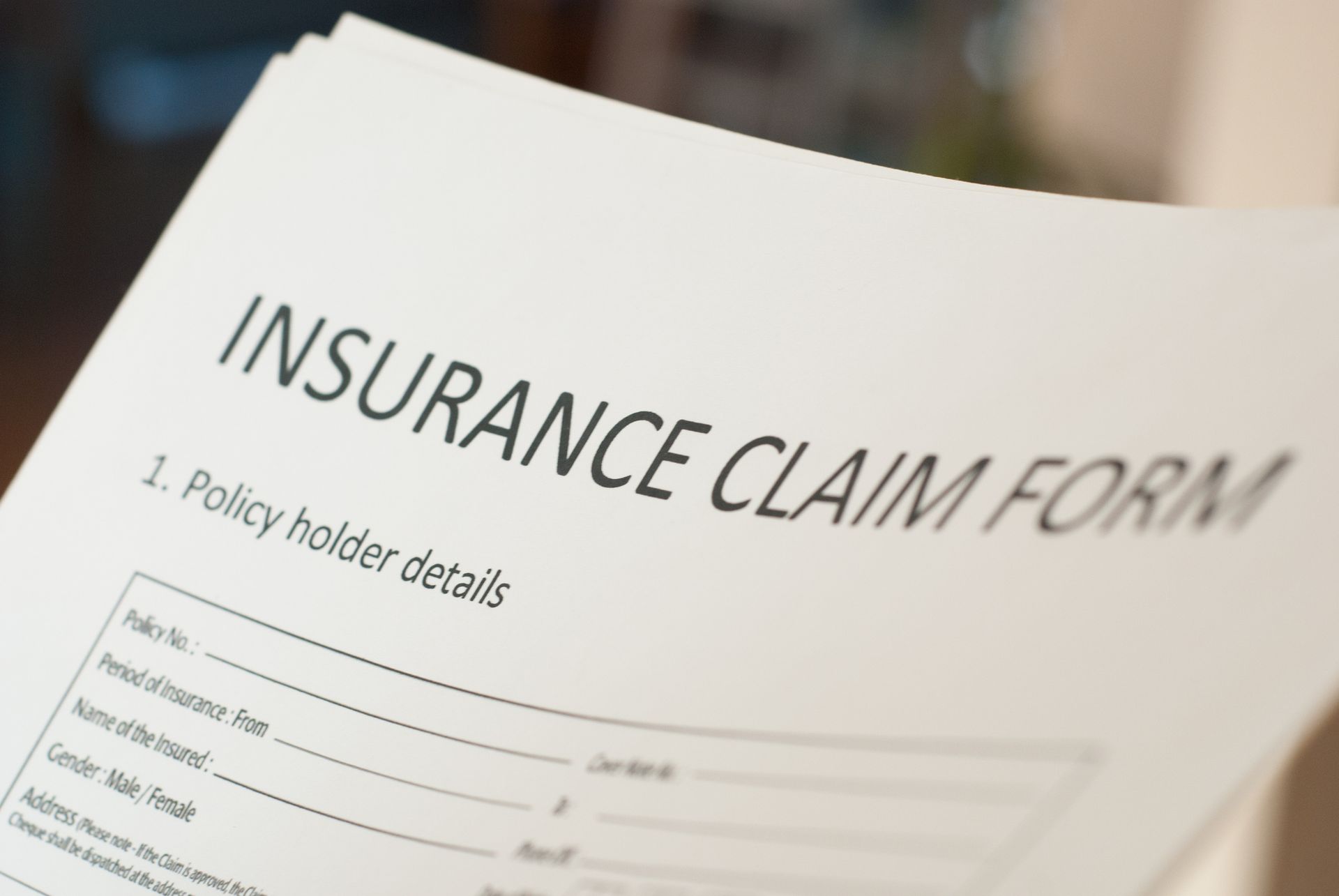 Close-up of a white insurance claim form with the title 