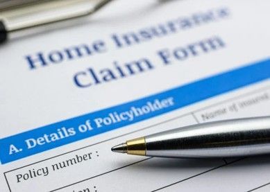 Close-up of a home insurance claim form with a pen resting on the document. Close-up of a home insurance claim form with a pen resting on the document.