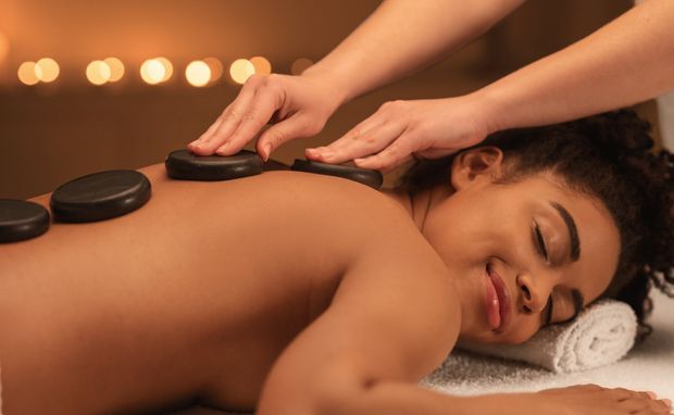 a woman getting a hot stone massage