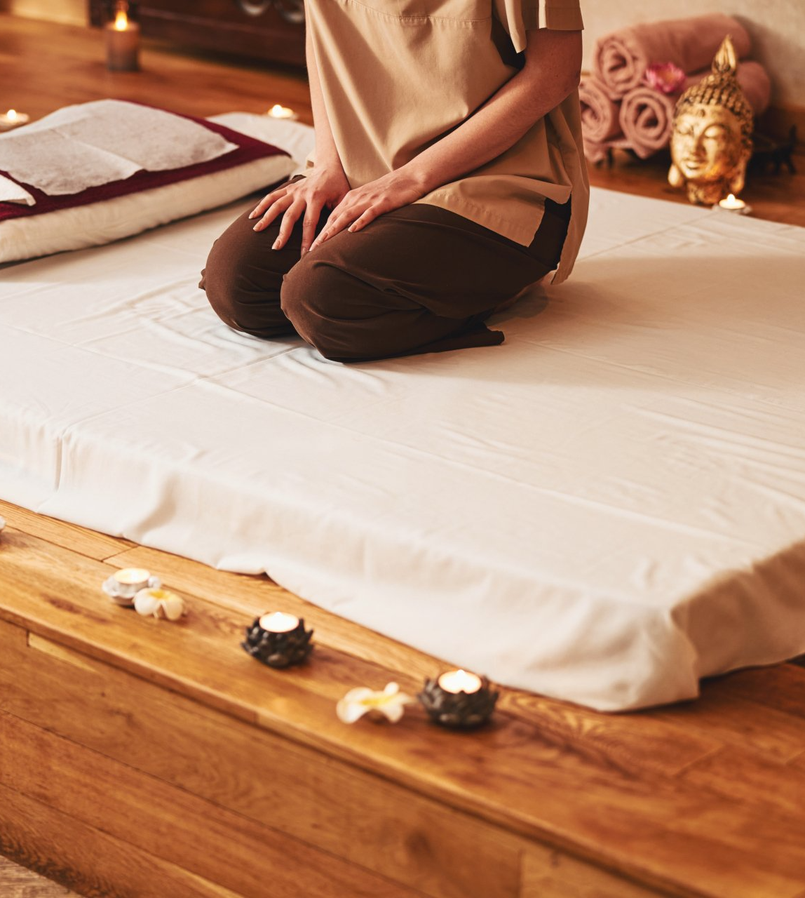 a person sitting on a mattress at a thai massage centre