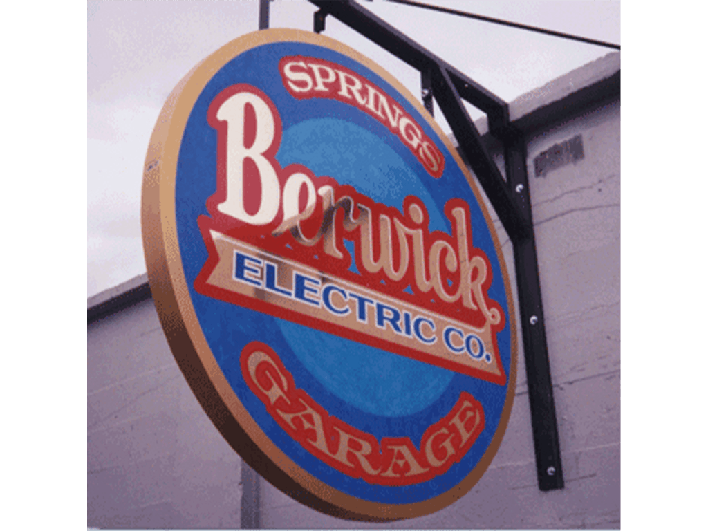 Suspended metal sign with gold foil logo