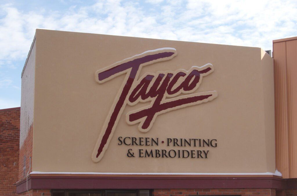 Cut out logo and letters on built up stucco finish