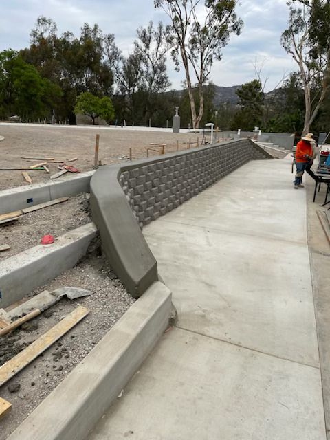 A concrete walkway is being built in a park