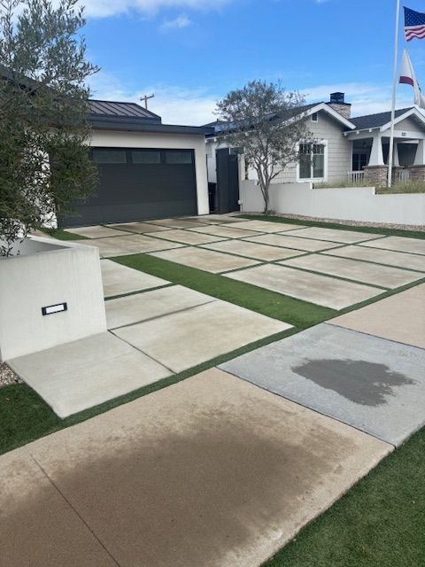 A house with a large driveway and a flag in front of it