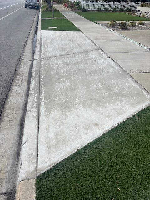 A sidewalk with a triangle in the middle of it