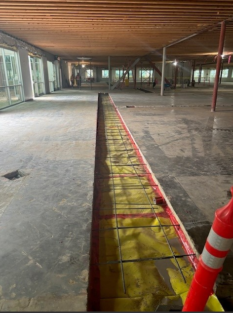 A concrete slab is sitting on top of a pile of dirt on a construction site.