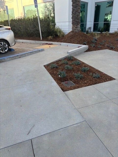 A white car is parked in a parking lot