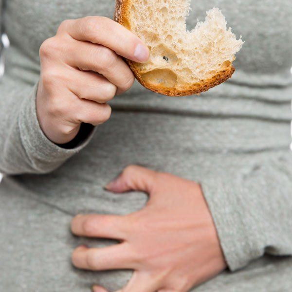 Man with Celiac Disease experiencing symptoms because he's eating bread