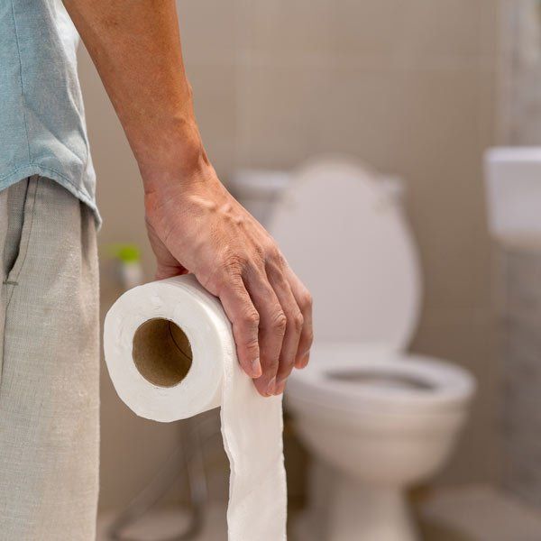 Man with  Diarrhea carrying toilet paper to the toilet