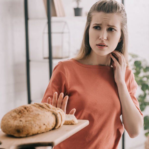 Woman with Gluten Intolerance refusing to eat bread