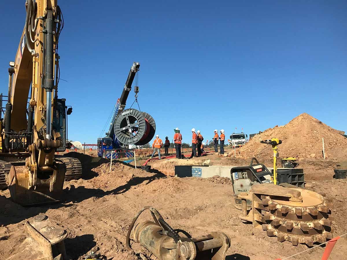 A Group of Construction Workers Are Working on a Construction Site — Country Powerline Constructions in Dubbo, NSW