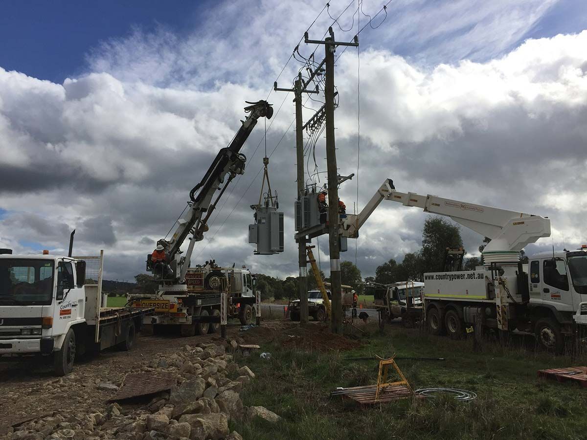 A Group of Construction Trucks Are Working on a Power Line — Country Powerline Constructions in Dubbo, NSW