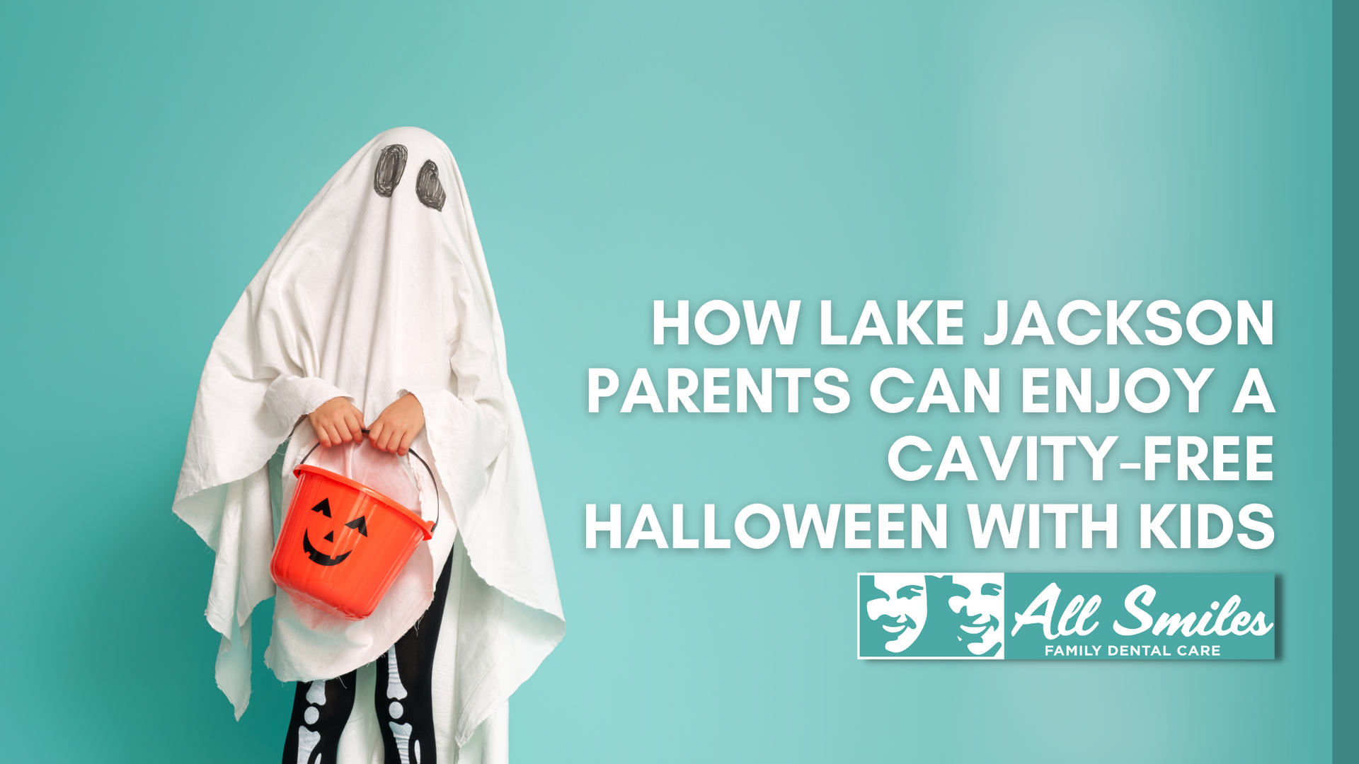 A child in a ghost costume is holding a pumpkin bucket.