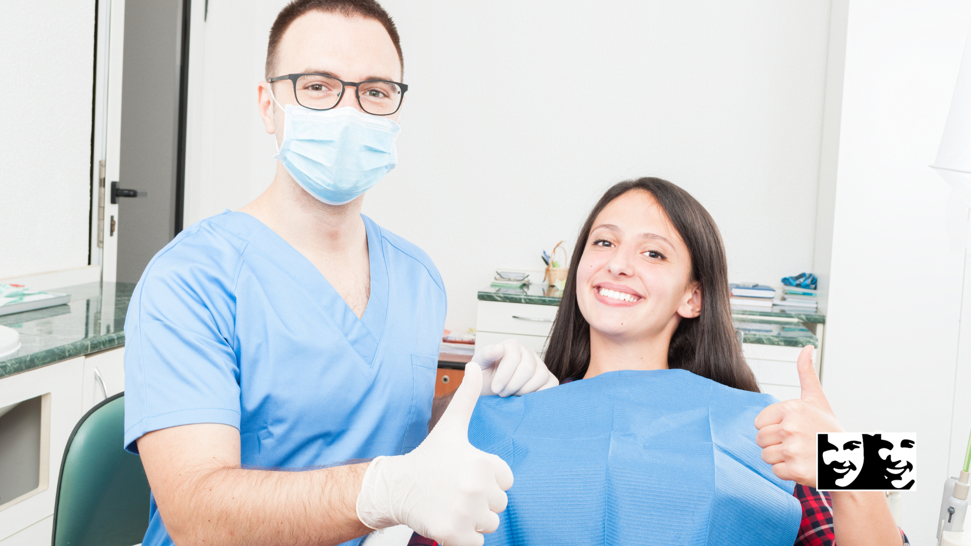 A dentist is giving a thumbs up to a patient in a dental chair.