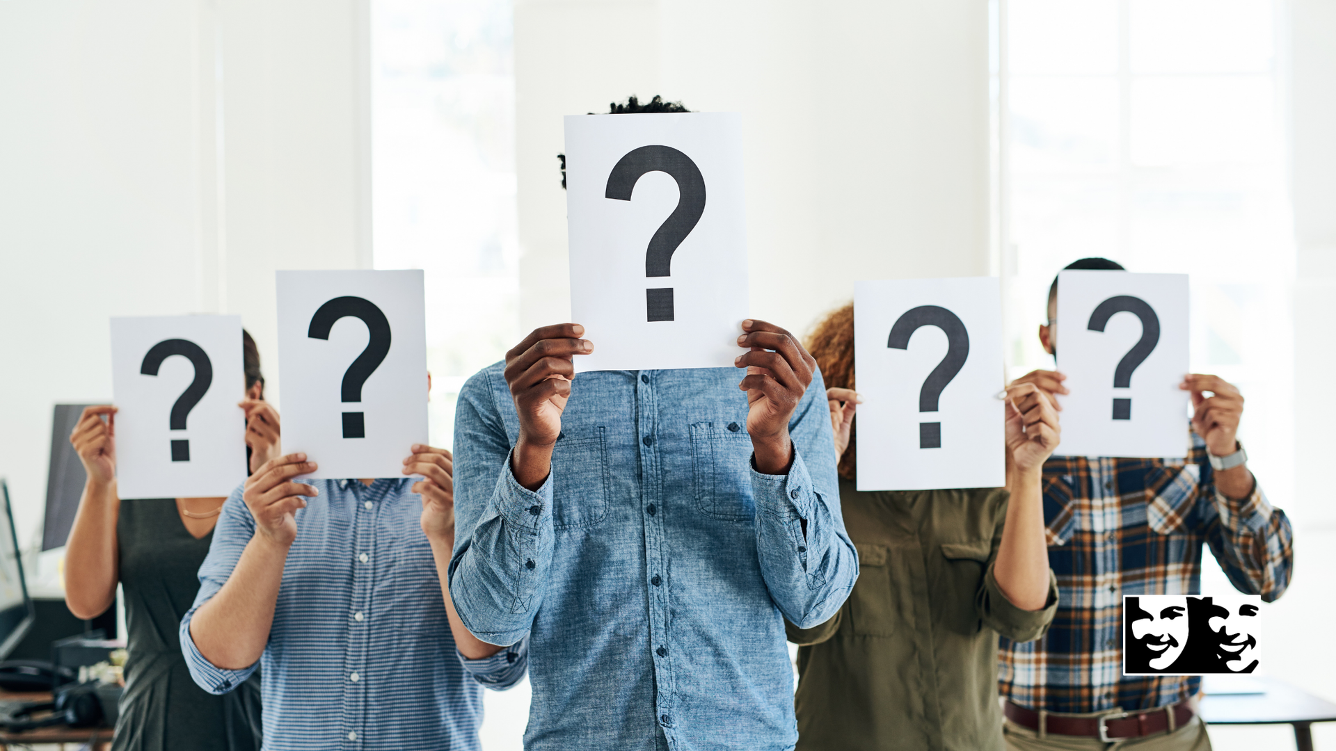 Five people holding question mark signs in front of their faces.
