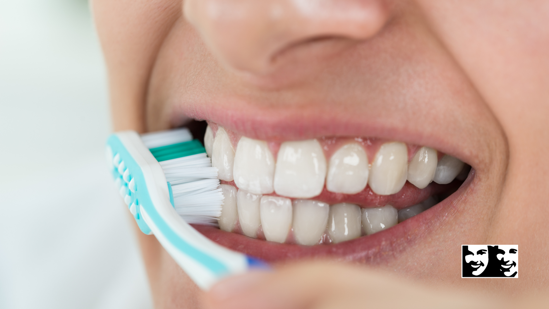 A close up of a person brushing their teeth with a toothbrush.