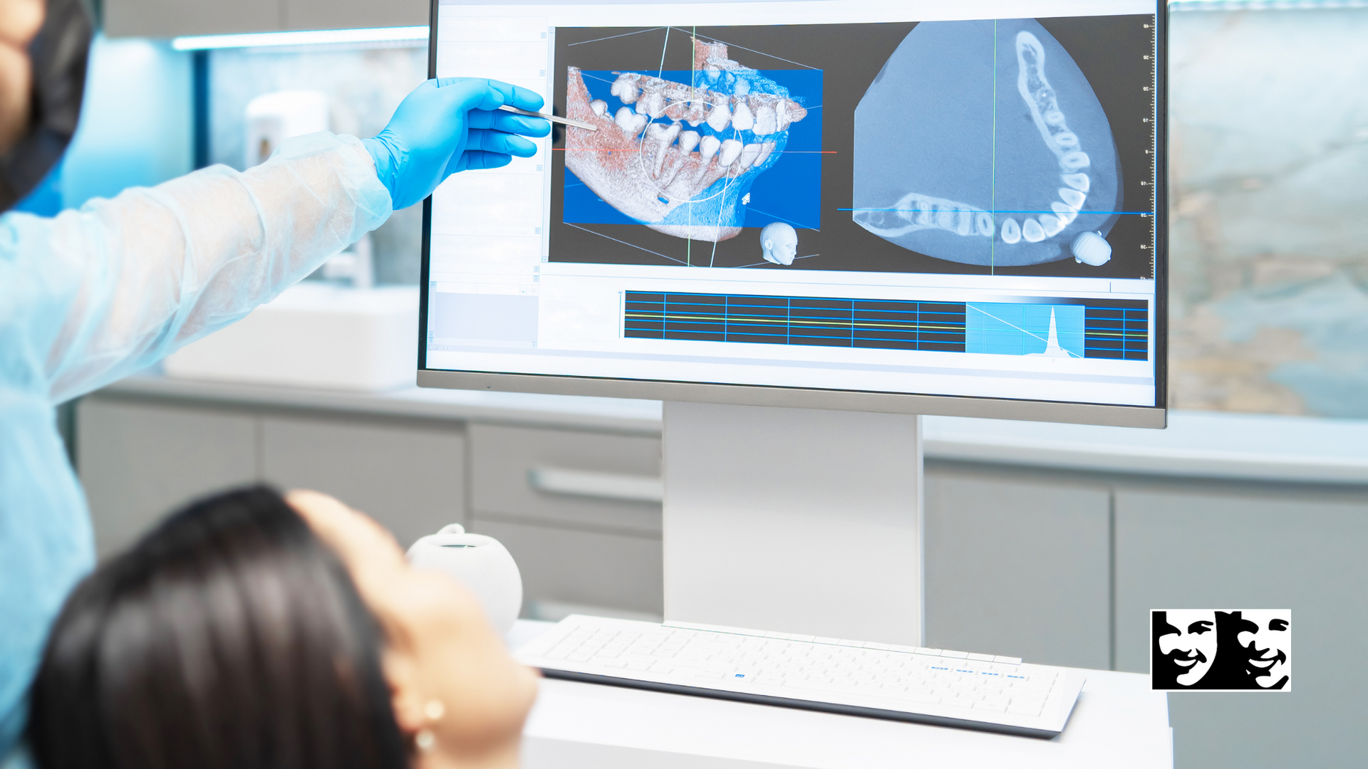 A dentist is looking at an x-ray of a patient 's teeth on a computer screen.