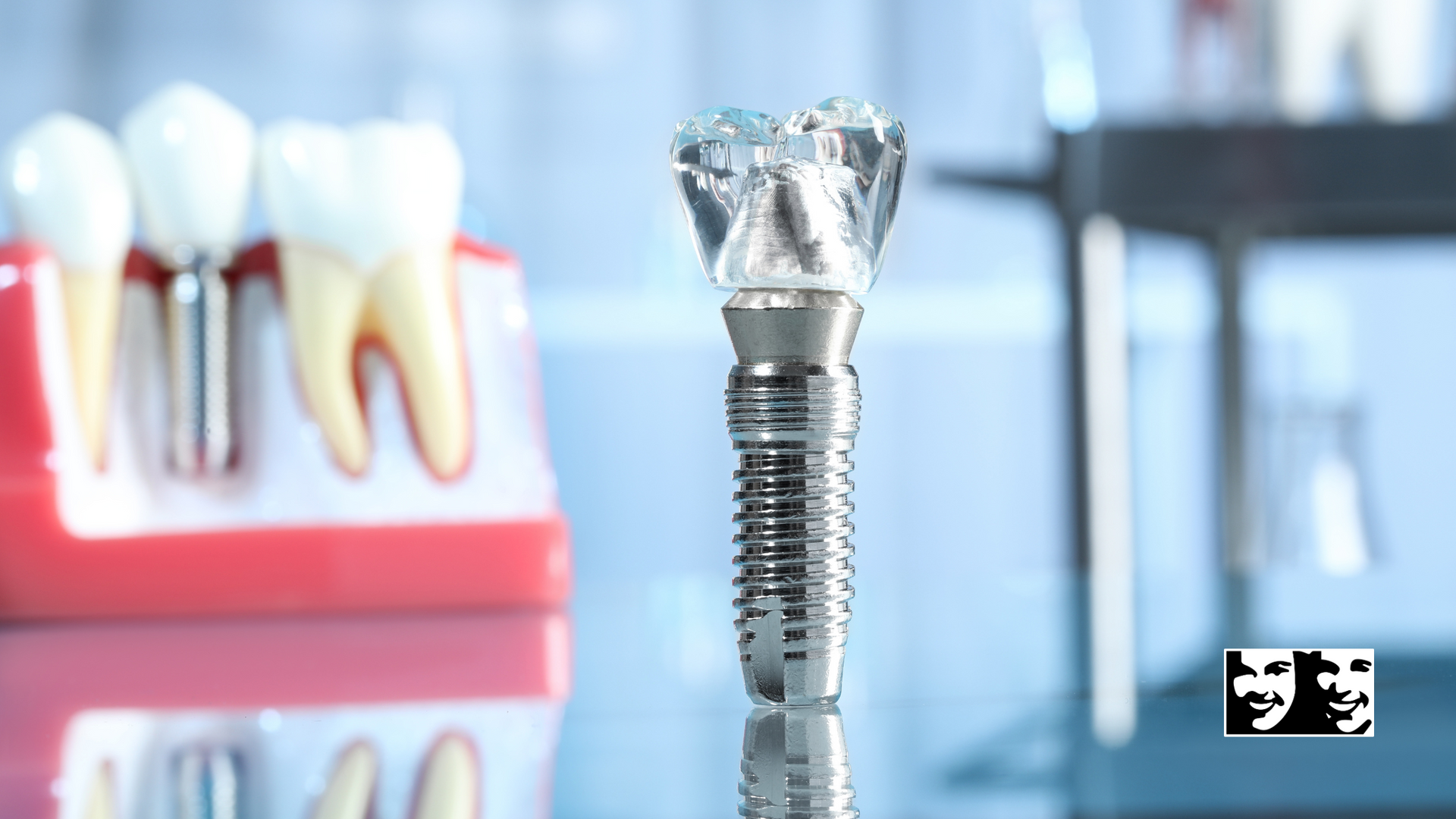 A dental implant is sitting next to a model of teeth