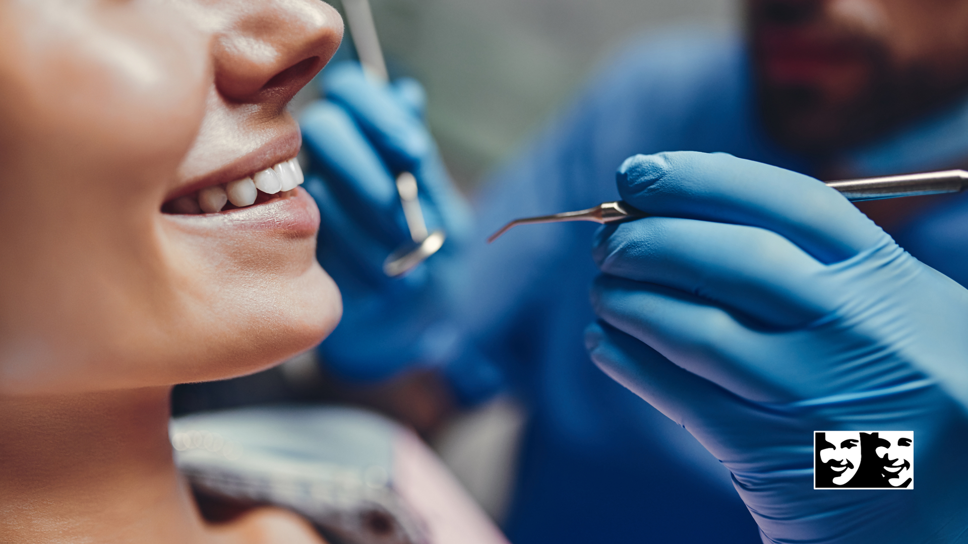 A woman is getting her teeth examined by a dentist.