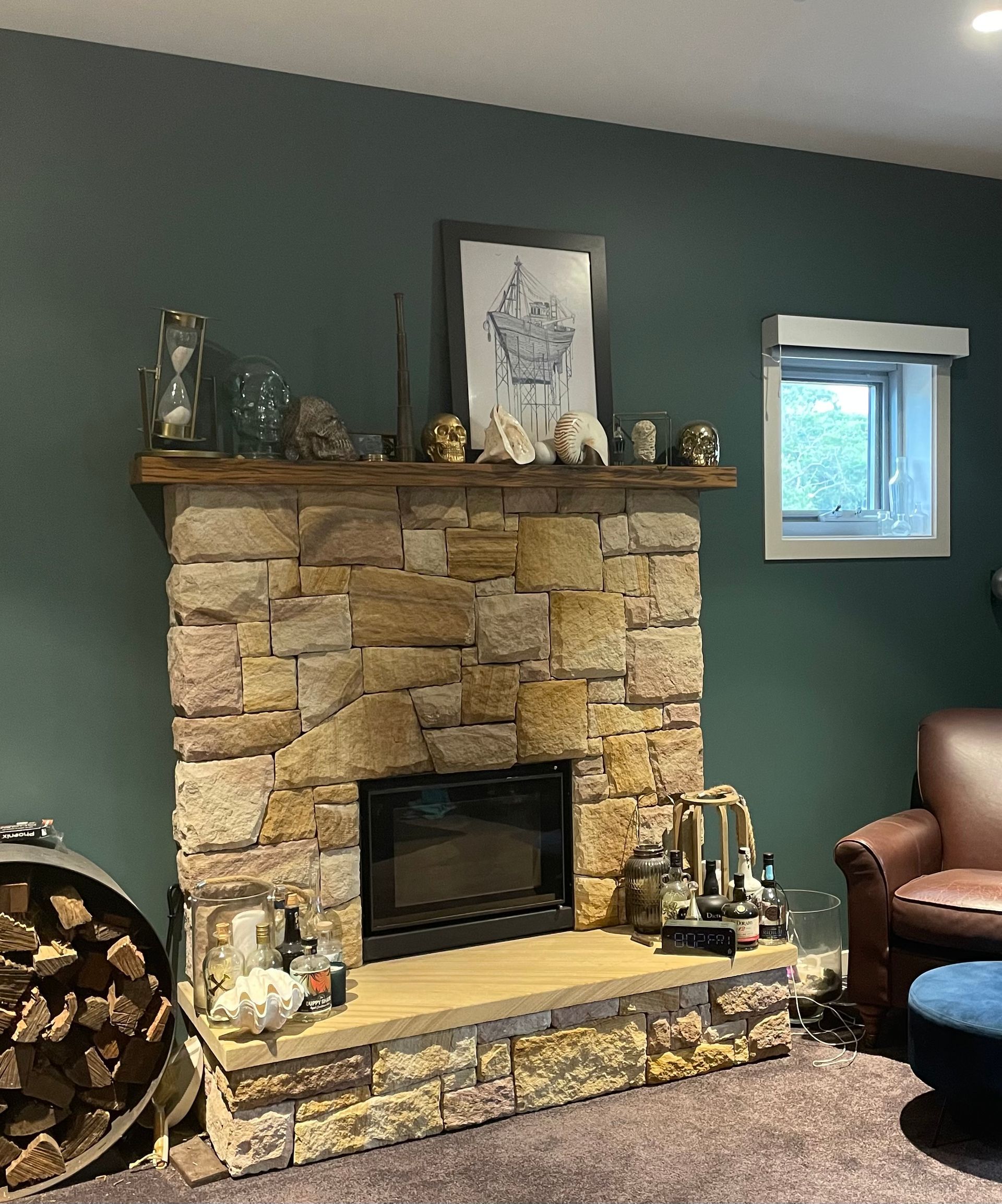 A living room with a stone fireplace and a chair — Timeless Painting In Umina Beach, NSW