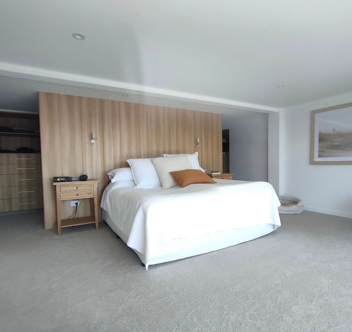 A bedroom with a large bed and a picture on the wall — Timeless Painting In Umina Beach, NSW