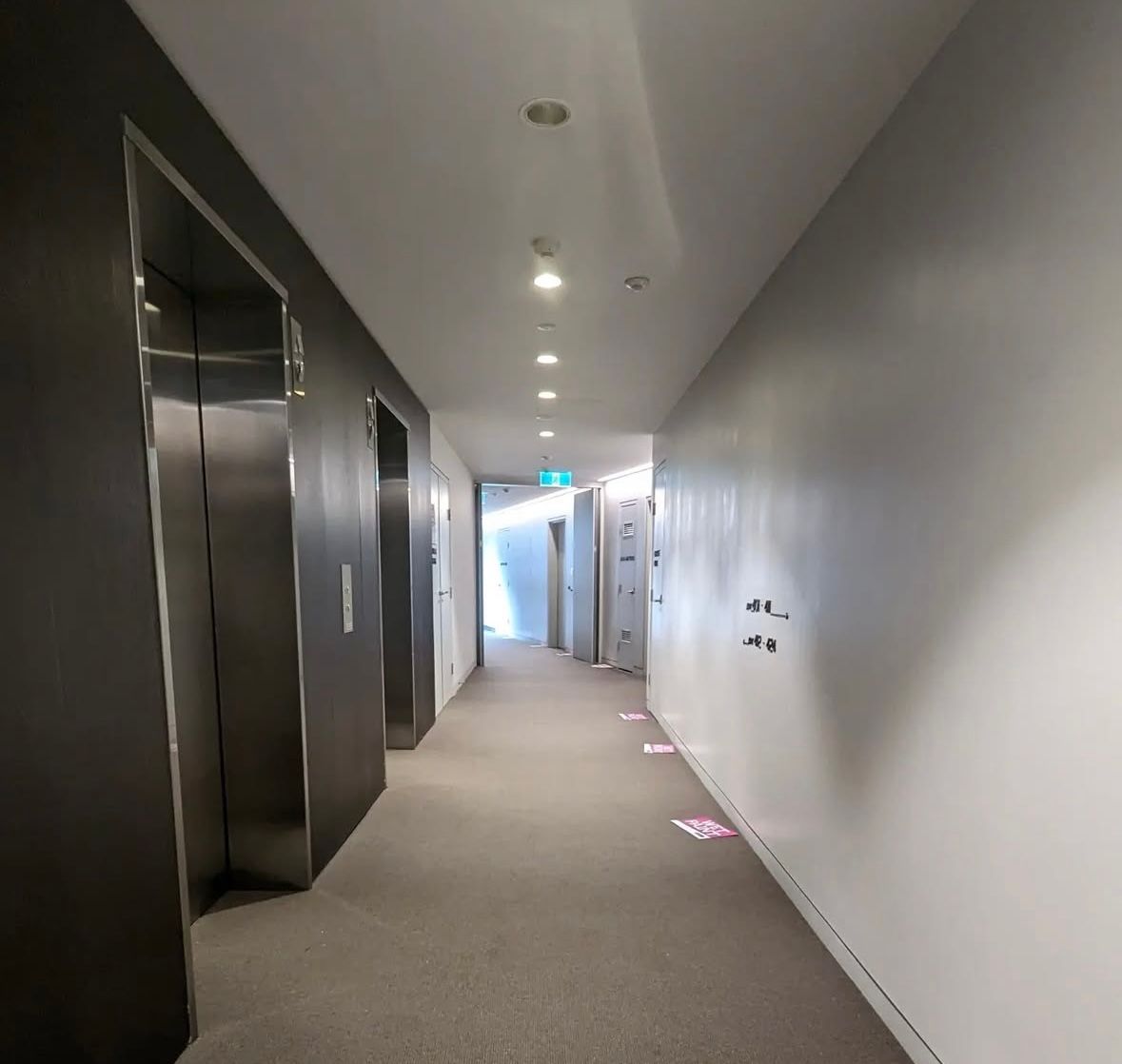 A long hallway with a few elevators in it — Timeless Painting In Umina Beach, NSW