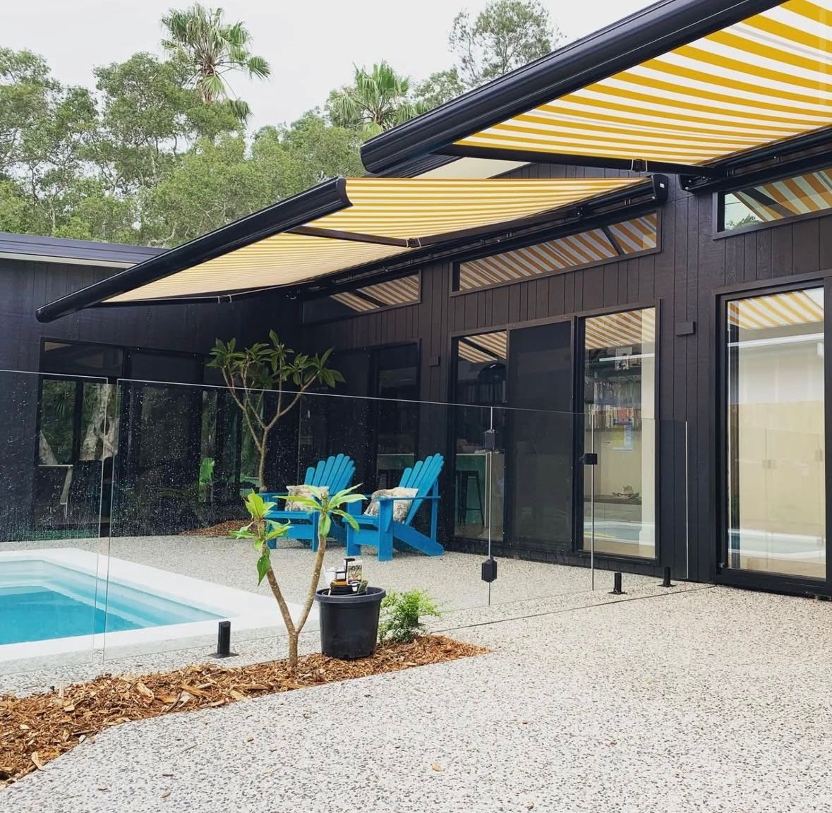 A house with a swimming pool and a yellow and black awning — Timeless Painting In Umina Beach, NSW