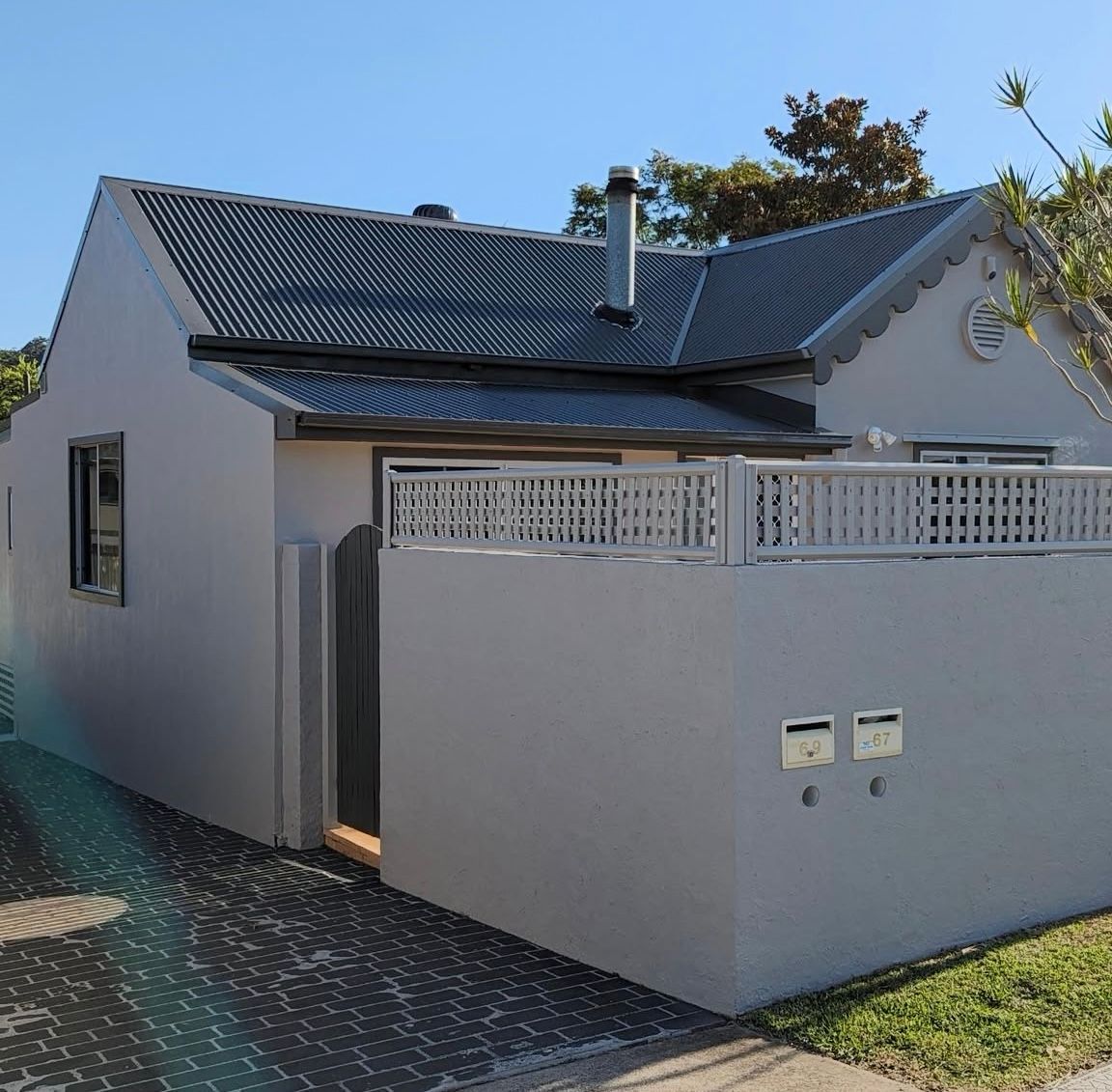 A small white house with a fence around it - — Timeless Painting In Umina Beach, NSW