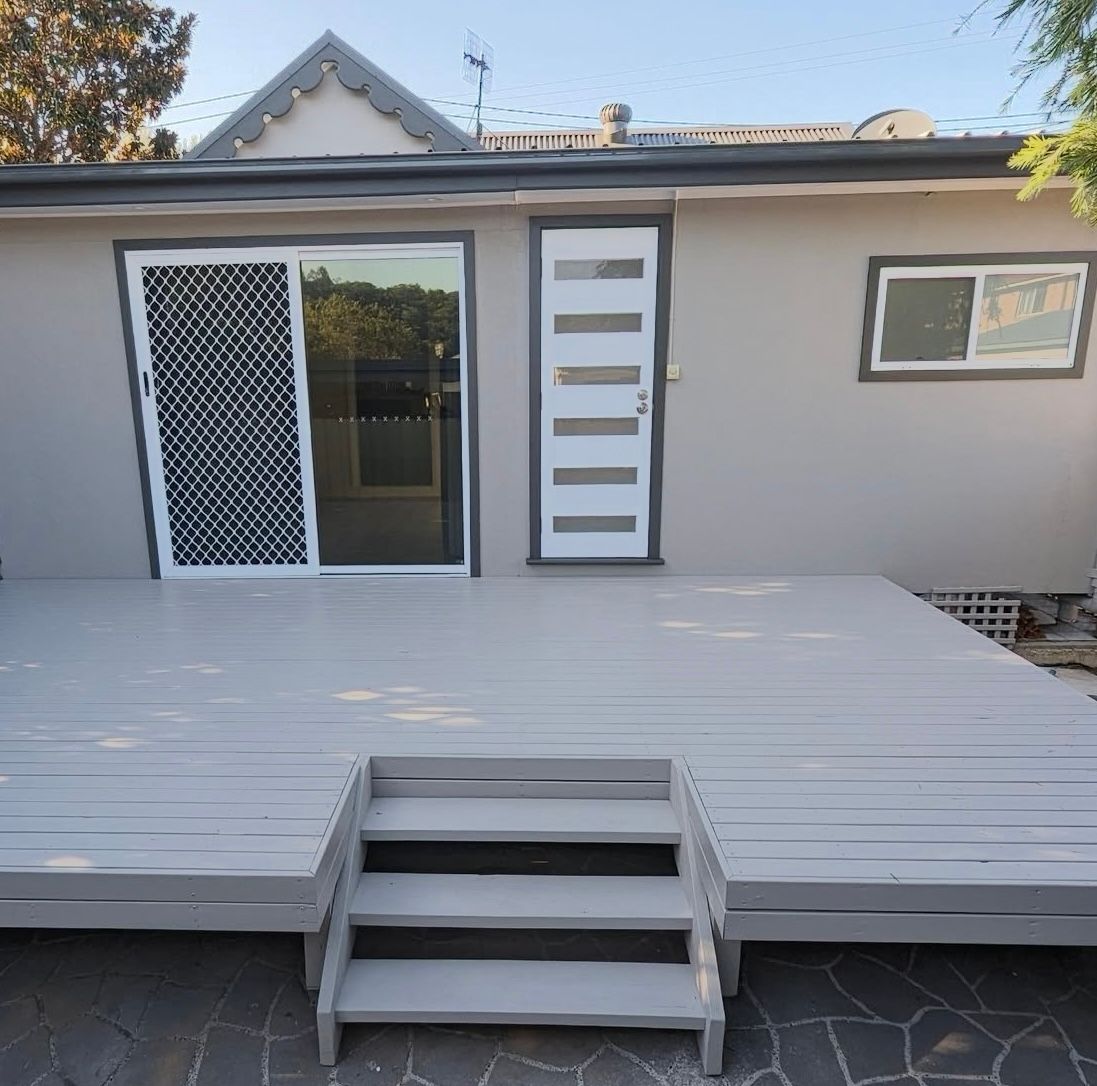 A house with a deck and stairs in front of i — Timeless Painting In Umina Beach, NSW