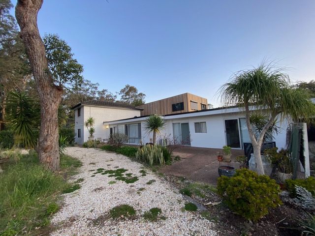 A large white house with a driveway leading to it is surrounded by trees and bushes — Timeless Painting In Umina Beach, NSW
