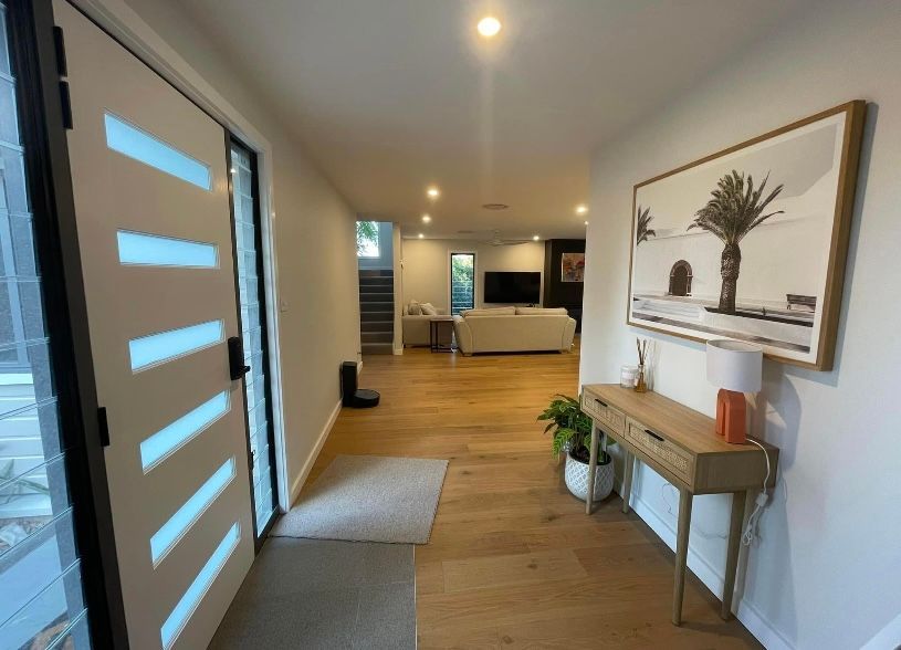 A hallway in a house with a table and a picture on the wall — Timeless Painting In Umina Beach, NSW