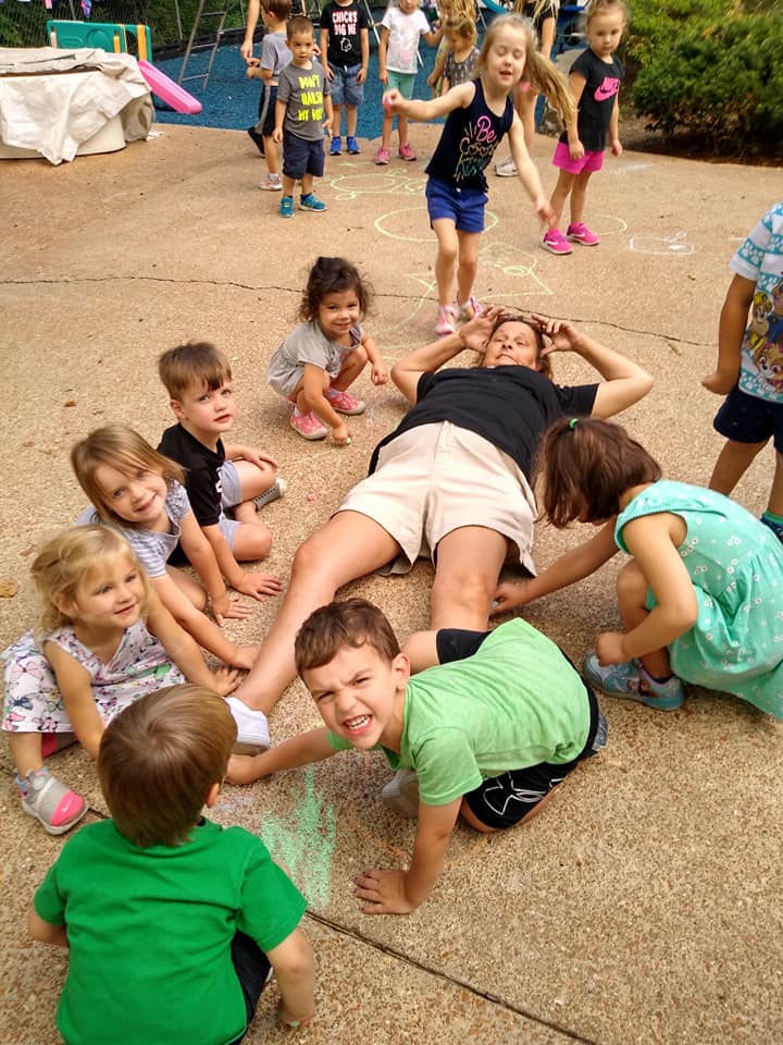Kids Lying on The Floor With There Teacher — St. Louis, MO — Sappington Child Care Center & Summer Day Camp