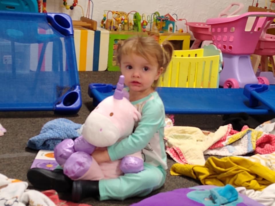 Baby Girl With Unicorn Stop Toy — St. Louis, MO — Sappington Child Care Center & Summer Day Camp