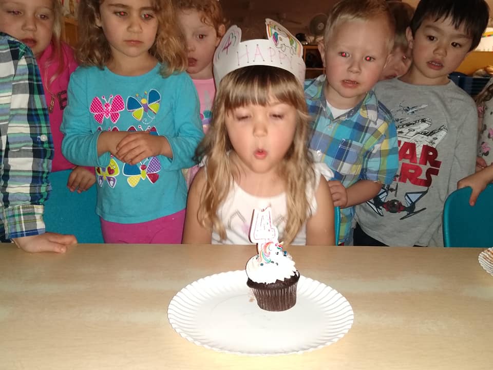 Girl Blowing The Candle on The Cupcake — St. Louis, MO — Sappington Child Care Center & Summer Day Camp