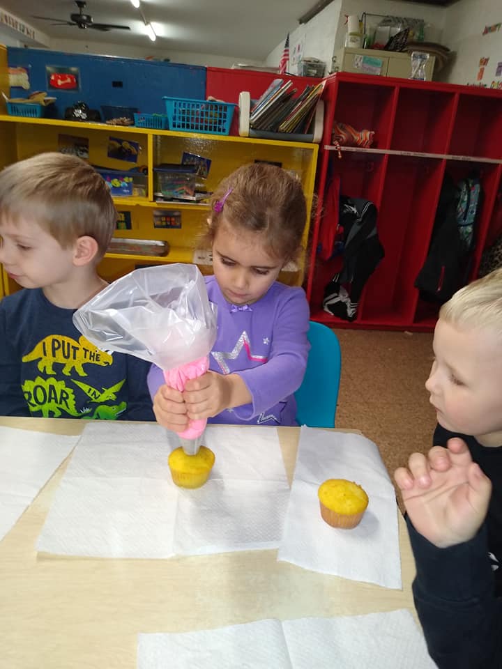 A Girl Adding an Icing on The Cupcake — St. Louis, MO — Sappington Child Care Center & Summer Day Camp
