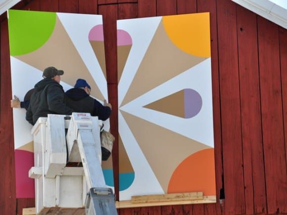 Men Fixing Ice Cream Signage — Shawano, WI — Raddant Electric Service Inc